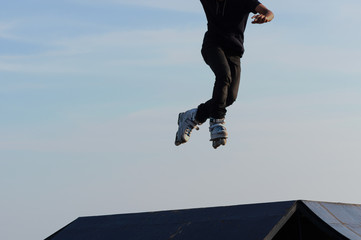Young man jump from ramp with roller skate