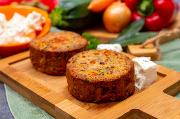 Tasty vegetarian food, burgers with Greek feta cheese, sweet red paprika, green olives and zucchini