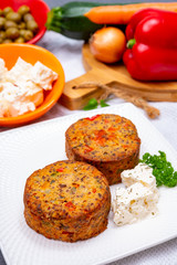 Tasty vegetarian food, burgers with Greek feta cheese, sweet red paprika, green olives and zucchini