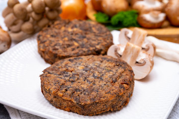 Tasty vegetarian food, burgers with champignons mushrooms, buna shimeji, carrot and onion