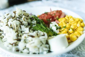 Vegan Healthy Mexican bowl with avocado, sweet corn, tomatoes, coriander, onion and rice