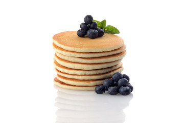 pile of fresh pancakes with blueberries and mint on white