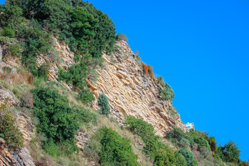 Fototapeta na wymiar Beautiful layered cliffs on a background of blue sea.