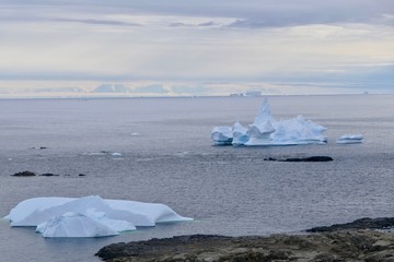 Scenic antarctic landscape, bay, islands and castle-shaped icebergs, Antarctica