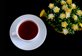 Herbal tea in a white mug on a black background. Suitable for advertising backgrounds and mockups