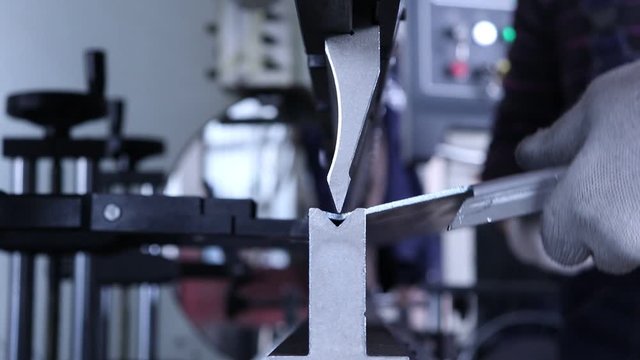 Bending metal on a bending machine. Metalworking on a bending machine