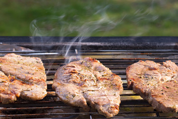 grilled meat is fried on the street, there is steam