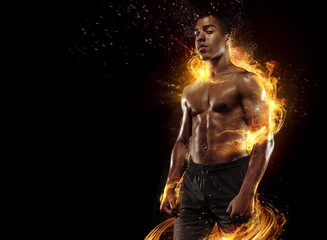 Fototapeta na wymiar Sport. Dramatic portrait of professional athlete. Winner in a competition. Fire and energy.