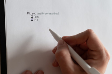A woman puts a daw in the questionnaire. Close-up of a female hand answering a question about a...