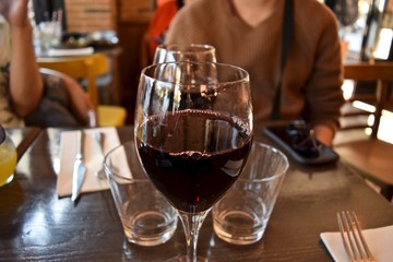 A glass of red wine on table in France.