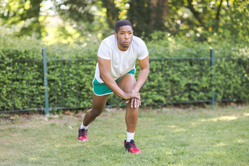 young man stretching in the park