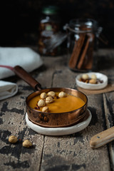Vegan Carrot Soup with Lentils on a wooden background, selective focus