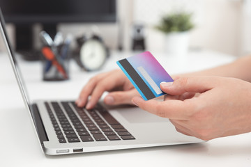 Online shopping, e-commerce. Credit card in hand.