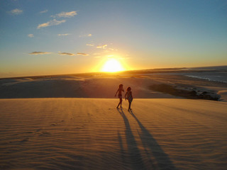 Amazing sunset in Jericoacoara beach in Ceara, Brazil, with people silhouette. Famosu place