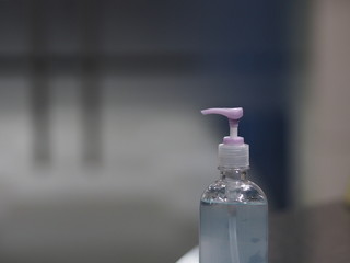 Hand Sanitizer, gel alcoholic mixture with gelatin in clear Plastic bottle with pump pushing wash clean dirty to prevent germs protect Contagious disease corona virus, covid-19