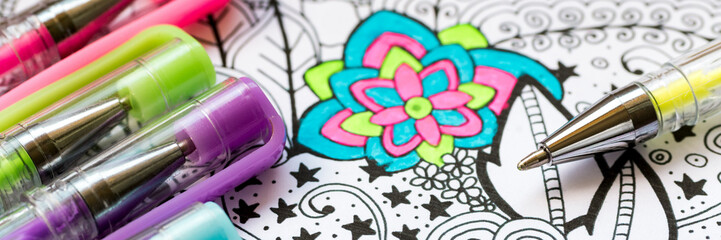Adult coloring book, stress relieving trend. Art therapy, mental health, creativity and mindfulness concept. Flat lay web banner, panoramic close up shot.