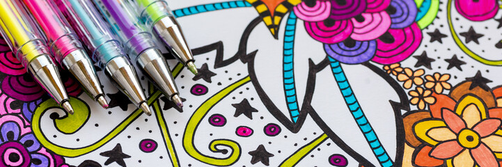 Adult coloring book, stress relieving trend. Art therapy, mental health, creativity and mindfulness concept. Flat lay web banner, panoramic close up shot.