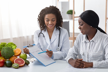 Friendly dietician explaining patient new treatment plan