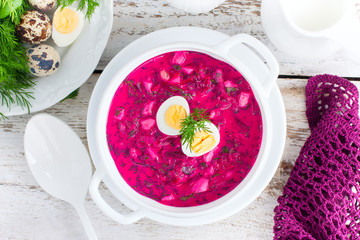 Traditional cold summer beetroot soup with vegetables, top view, selective focus
