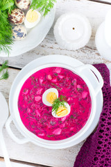 Traditional cold summer beetroot soup with vegetables, top view, selective focus