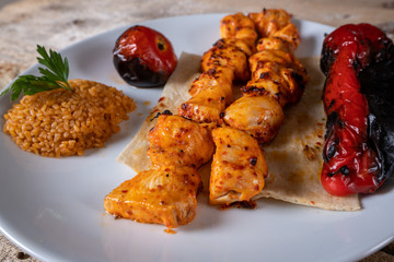 Kebabs - grilled meat and vegetables. Grilled chicken breast. Fried chicken fillet and fresh vegetable salad of tomatoes, cucumbers and arugula leaves.
Grilled chicken legs with spices and garlic.