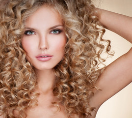 Beautiful blonde woman. Healthy Long Blond Hair. Curly Hair. Blond. Permed Hair. Afro curls. Long blond Hair.  Beauty Model Girl with Luxurious Hair.