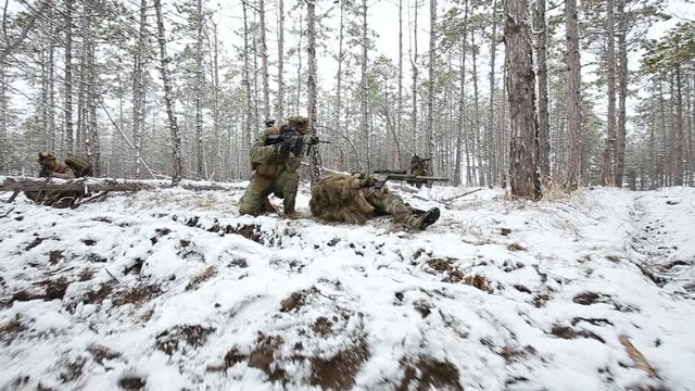 Airsoft. A soldier was wounded in a firefight. the other drags him into cover