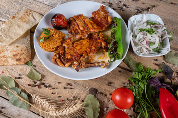 Kebabs - grilled meat and vegetables. Grilled chicken breast. Fried chicken fillet and fresh vegetable salad of tomatoes, cucumbers and arugula leaves.
Grilled chicken legs with spices and garlic.