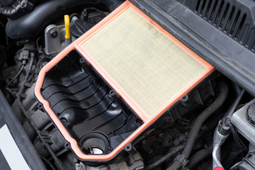 Open air box with new filter in car engine bay. Mechanic repair or vehicle maintenance concept.