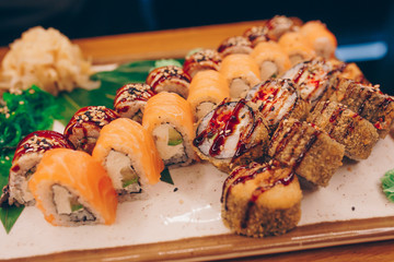 Large set of Sushi Rolls Warm Ebi Sake Unagi Spring. A lot assortment Philadelphia roll Dishes from Japanese raw fish  in one plate in traditional restaurant. Japan food menu service
