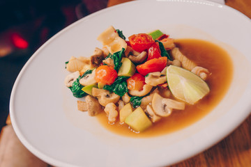 Waiter serving warm Salad asparagus  squid shrimp at restaurant, close up view. Eating and leisure concept. Toned image. Design healthy lifestyle Organic Gourmet and luxury concept service