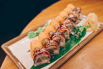 Large set of Delicious sushi rolls view from above Flat Lay . A lot assortment Philadelphia roll Dishes from Japanese raw fish  in one plate in traditional restaurant. Japan food menu service