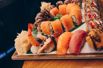 Large set of Delicious sushi rolls view from above Flat Lay . A lot assortment Philadelphia roll Dishes from Japanese raw fish  in one plate in traditional restaurant. Japan food menu service