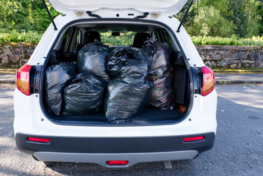 Black Plastic Bin Bags Full Tied And In Car Boot With Door Open For Fly Tipping