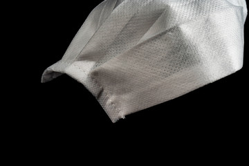 Close-up shot of medical mask isolated on black background. Copy space for text message.