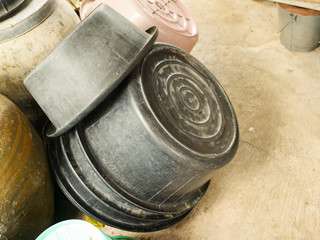 Black plastic basin that is stacked upside down.