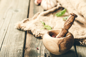 Cooking background. Wooden mortar and pestle, herbs and spices, copy space