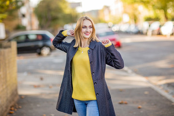 happy young woman walking down the street