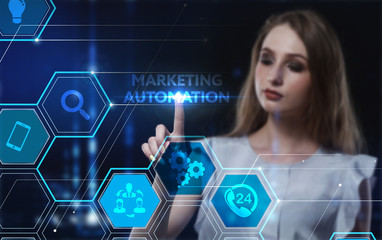 Business, Technology, Internet and network concept. Young businessman working on a virtual screen of the future and sees the inscription: Marketing automation