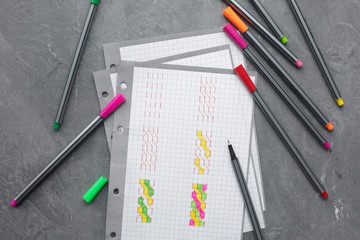 paper with colored pens on the table
