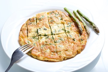 Omelette with asparagus in white background