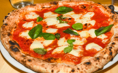 Pizza Margherita is a typical Neapolitan pizza, made with San Marzano tomatoes, mozzarella cheese