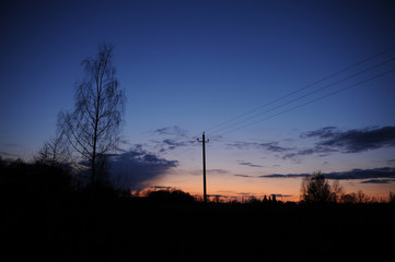 Power lines at sunset in the village