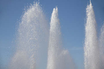 Massive water fountains spraying clear sparkling water into a beautiful blue sky in a wonderful display 