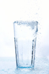 Naklejka na ściany i meble Full glass of water isolated on white background