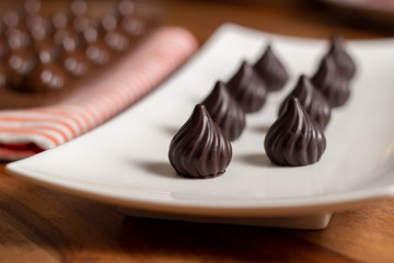 drop-shaped chocolates in a white plate