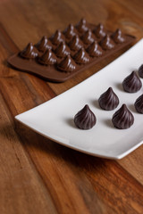 drop-shaped chocolates in a white plate