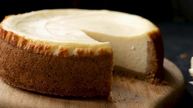 Slice of new york cheesecake closeup view. Taking piece of cake