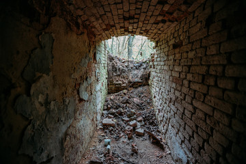 Historical underground red brick passage. Light at the end of tunnel