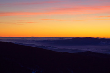 Beautiful golden sky after sunset seen from Sereak mountain in Czech Republic